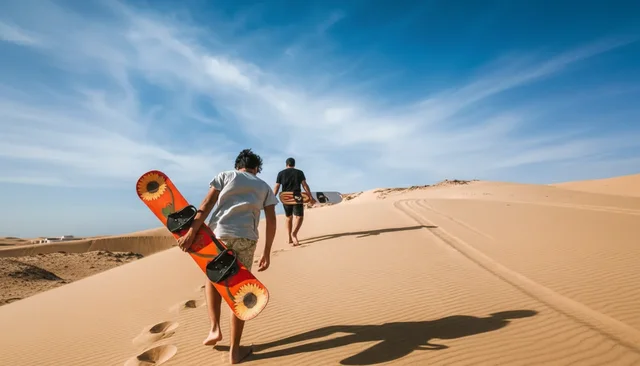 Visitors carrying a sandboard up a coastal dune
