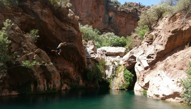 Rock walls and a green pool in Tizgui Valley
